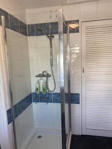 een badkamer met een douche en een glazen deur bij Aberlour Apartment 92 B in Aberlour
