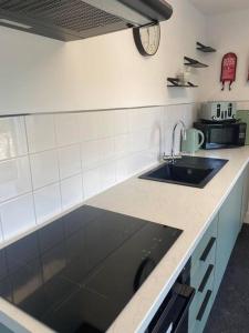 a kitchen with a sink and a counter top at Aberlour Apartment 92 B in Aberlour