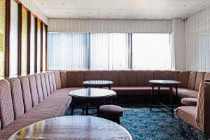 a waiting room with couches and tables at OYO Harlands Hotel in Blackpool