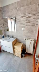 a bathroom with a sink and a mirror at Appartamento Aris in Monfalcone