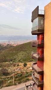 a tall building with a view of a city at YEMMA GOURAYA LOFT in Bejaïa