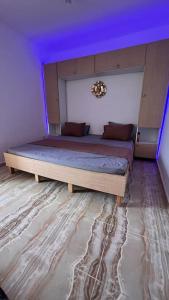 a bedroom with two beds with a purple ceiling at YEMMA GOURAYA LOFT in Bejaïa