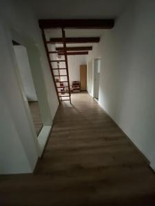 an empty hallway with a staircase in a building at Casă de vacanță în zona montană in Sântimbru-Băi