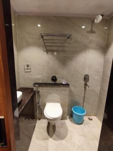 a bathroom with a toilet and a sink at HOTEL B S HEIGHTS in Deoghar