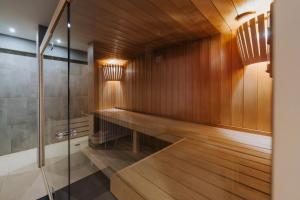 a sauna with wood paneling and a glass door at Ferienapartments Müller in Ebene Reichenau +13 photos