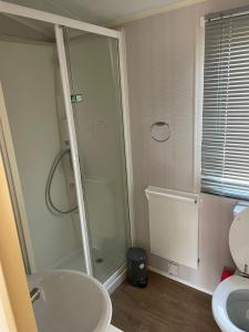 a bathroom with a shower and a toilet and a sink at The Breakaway in Rochester