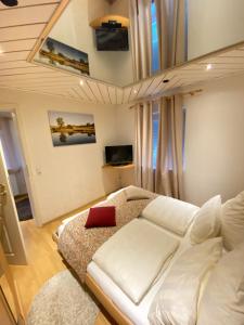 a living room with a white couch and a red pillow at Apartment in See Nähe in Salzgitter