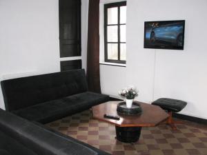 a living room with a couch and a coffee table at Ferme Des Chapelles in Fresnes-en-Tardenois