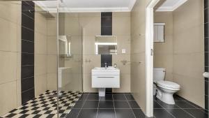 a bathroom with a toilet and a sink and a shower at Anchor Bay Workation in Cape Town +67 photos
