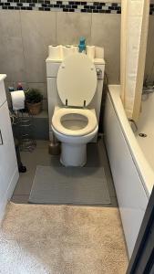 a bathroom with a toilet and a bath tub at 3 Bedroom Flat in King’s Cross, St Pancras’s. 8 People in London