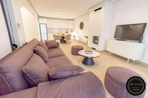 a living room with a large couch and a flat screen tv at Mi Casa 2 in Vrdnik