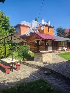 a house with a picnic table in front of it at Borgaza in Yaremche