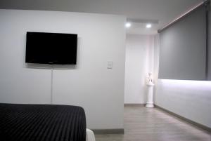 a room with a flat screen tv on a wall at Luxury 79 in Bogotá
