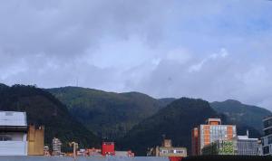 a view of a city with mountains in the background at Luxury 79 in Bogotá