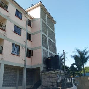 a building with a water tank on the side of it at Milly's homes in Kakamega