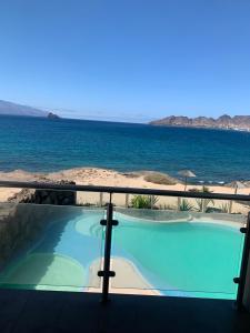 a swimming pool with the ocean in the background at Lazareto Oceanview in Mindelo