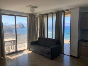 a living room with a couch and views of the ocean at Lazareto Oceanview in Mindelo