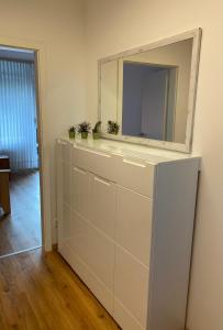 a mirror on top of a white dresser in a room at Marl Central Apartment in Marl