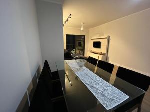 a kitchen with a glass counter top in a room at Apartamento aconchegante e espaçoso! in Guarujá