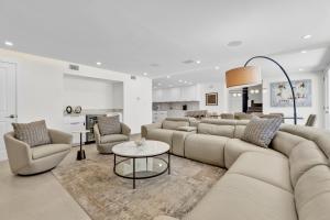 a living room with a large couch and chairs at 4 bd Luxury Beachfront Condo with Private Pool &Terrace in South Padre Island