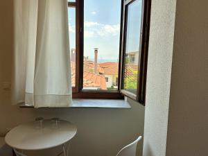a window in a room with a table and a sink at 7PocketHouse in Thessaloniki