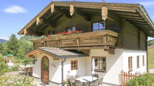 a house with a balcony on top of it at Ferienhaus Sommerbichl in Zell am See