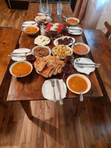 a wooden table with a bunch of food on it at Fafo in Zhabeshi