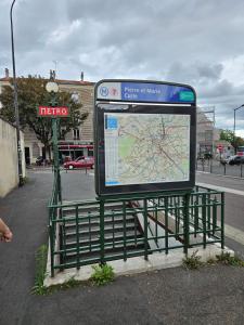 a bus stop sign sitting next to a map at STUDIO 22M2 A IVRY/SEINE-A 200 METRES DE PARIS. PROCHE METRO 7 in Ivry-sur-Seine