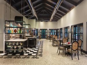 um restaurante com mesas e cadeiras em uma sala em ITC Grand Goa, a Luxury Collection Resort & Spa, Goa em Utorda mais 37 fotografias