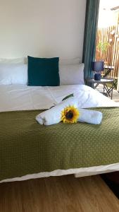 a bed with a sunflower sitting on top of it at Urban Retreat in London