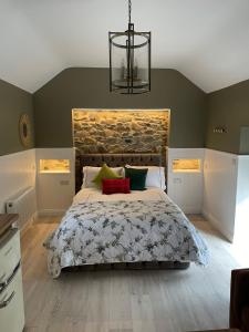 a bedroom with a large bed and a chandelier at Toddys Hideaway in Cavan