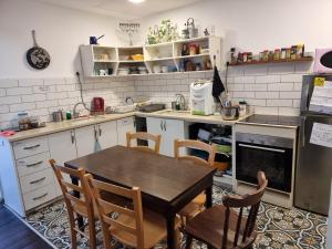 a kitchen with a table and chairs in it at Haifa Hostel in Haifa