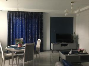a living room with a dining table and a television at Apartament Janów Podlaski in Janów Podlaski