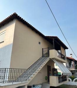 a house with a staircase on the side of it at Evi's apartment Pefkochori in Pefkochori +4 photos