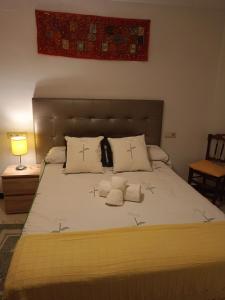 a bedroom with a large bed with two pillows at Reyes in Monachil