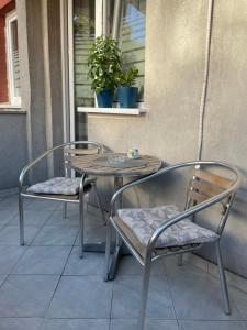 two chairs and a table on a patio at JOVAN APARTMAN in Rospi Ćuprija