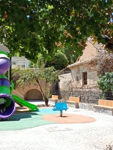 a playground with a slide in a park at Reyes in Monachil
