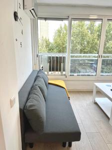 a couch in a room with a large window at Apartment Ducado 41 Benidorm Playa levante 4 P in Benidorm