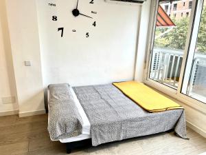 a room with a bed and a clock on the wall at Apartment Ducado 41 Benidorm Playa levante 4 P in Benidorm