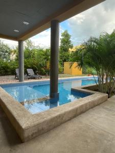 a swimming pool with blue water in a house at Casa Indica Colombia in Girardot