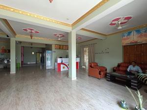 a living room with couches and chairs in a room at Hotel Narayani in Rājgīr