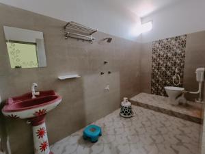 a bathroom with a sink and a toilet at Hotel Narayani in Rājgīr