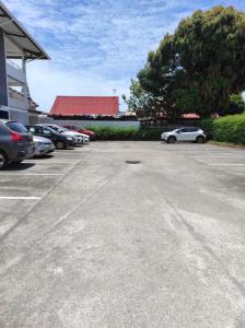 a parking lot with a lot of cars parked at La Coraline Standing in Kourou