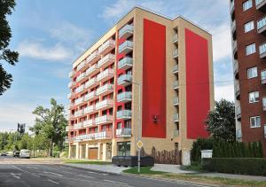 un grande edificio rosso sul lato di una strada di Luxury Grand Apartments by Bratislavatrip a Bratislava