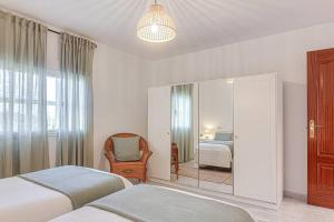 une chambre avec deux lits et un miroir dans l'établissement Casa Herminia, à Coristanco