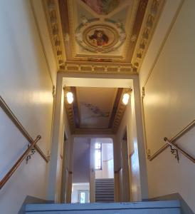 an ornate ceiling and stairs in a building at Finka Monika in Dresden