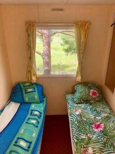 a small room with two beds and a window at Holenderki na Zielonych Wzgórzach, Łowyń in Łowyń +47 photos
