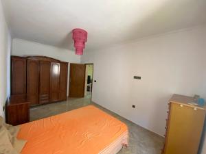 an empty room with a bed and a cabinet at Sea house in Nador