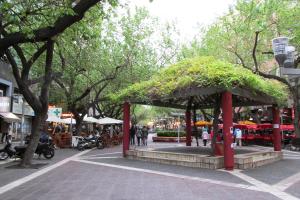 a pavilion on a city street with people and trees at Departamento en peatonal Mendoza in Mendoza