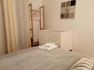 a bedroom with a bed with towels on it at Confortable + in Serris